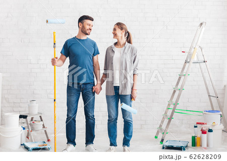 Couple with paint and instruments planning home repair 62628209