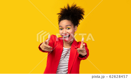 Happy black woman choosing you over yellow background 62628457