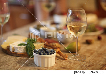 Dinner with snacks and wineglasses on table in 62628662