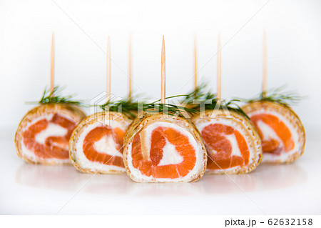 Rolls of pancakes filled with smoked salmon and cream cheese 62632158