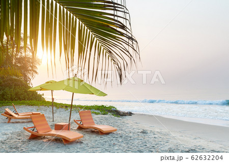 Beach chair under the big umbrella and was on the beach. Beautiful beach. Chairs on the sandy beach near the sea. Summer holiday and vacation concept for tourism. Inspirational tropical landscape. 62632204