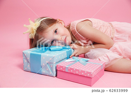 Cute little girl with gift box at birthday party Cute little girl with gift box at birthday party 62633999