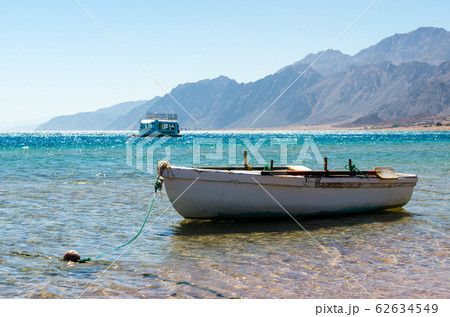 old wooden fishing boat in the sea old wooden fishing boat in the sea 62634549