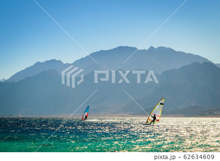 surfers ride in the sea on the background of the rocky coast in Egypt Dahab 62634609