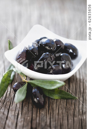 Bowl with black olives on table Bowl with black olives on table 62635656