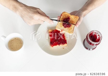Top view spreads cherry jam on toast Top view spreads cherry jam on toast 62636596