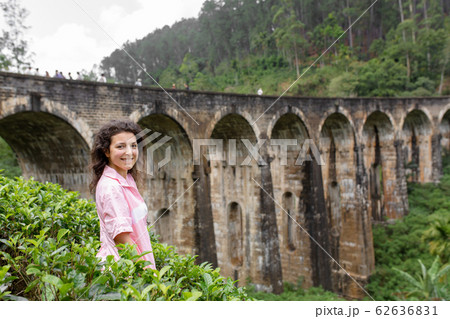 A tourist poses in a tea plantation near the A tourist poses in a tea plantation near the 62636831