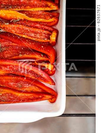 Baked red sweet bell pepper in a white ceramic baking dish. Flat lay. Copy space 62637671