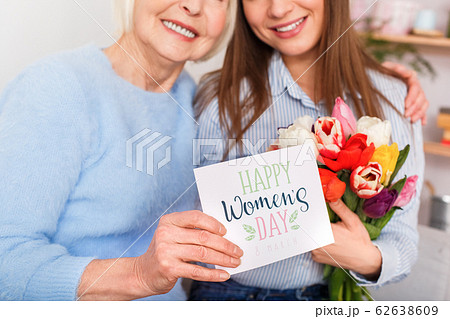 Mom is hugging her daughter and smiling Mom is hugging her daughter and smiling 62638609