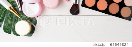 cosmetic makeup and skin care product and leaves on white wood table 62642824