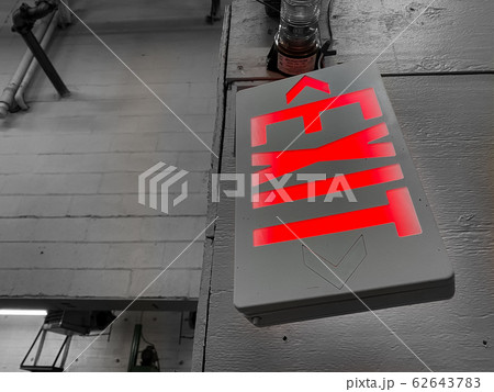 A Broken Sideways Hanging Red Exit Sign A Broken Sideways Hanging Red Exit Sign 62643783