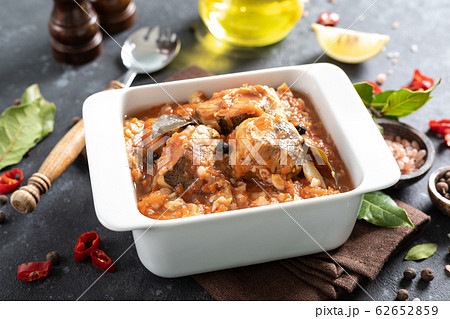 Hake fish, cooked in tomato sauce with vegetables 62652859