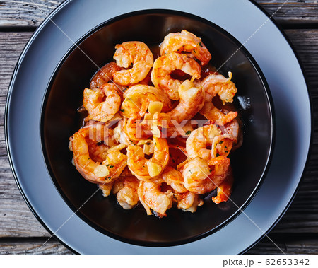 Shrimp scampi on a black plate, top view 62653342
