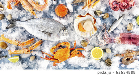 Fish and seafood variety, a flatlay panoramic shot. Sea bream. shrimps, crab, sardines, squid, scallops, shot from above Fish and seafood variety, a flatlay panoramic shot. Sea bream. shrimps, crab, sardines, squid, scallops, shot from above 62654989