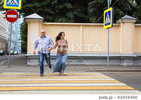 Loving pregnant couple on city street Loving pregnant couple on city street 62656400