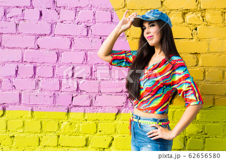 Street dance, freestyle and jazz funk concept - Beautiful girl hip-hop dancer over brick wall with copy space. Street dance, freestyle and jazz funk concept - Beautiful girl hip-hop dancer over brick wall with copy space. 62656580