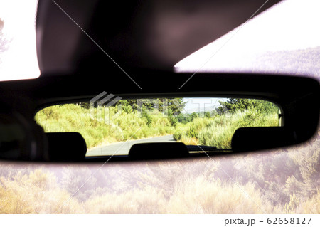 rural highway reflected in the glass of a car rural highway reflected in the glass of a car 62658127