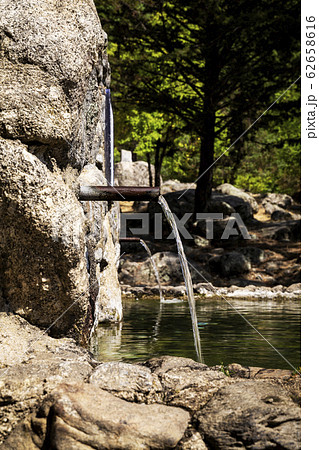 stream of fresh water coming out of a metal spout stream of fresh water coming out of a metal spout 62658616