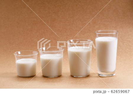glasses of milk arranged as increasing height. 62659067