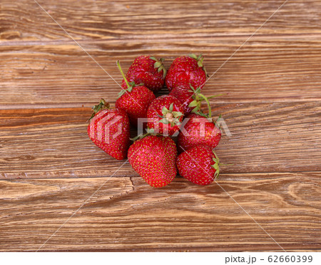 Ripe strawberries, isolated on wooden background. Ripe strawberries, isolated on wooden background. 62660399