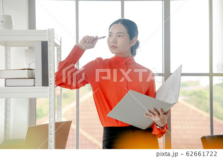 Business woman is reading documents view through Business woman is reading documents view through 62661722