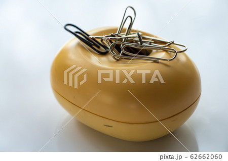 Paper clips in beige plastic oval box on white acrylic background, Close up & Macro shot, Business, Education, Stationery concept Paper clips in beige plastic oval box on white acrylic background, Close up & Macro shot, Business, Education, Stationery concept 62662060