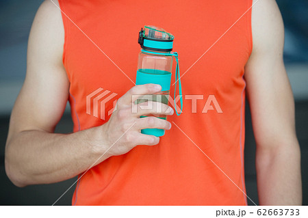 Hand holds sportive bottle of water or sport 62663733