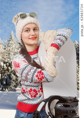 portrait of a happy young girl snowboarding with 62663734