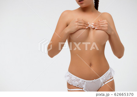 Crop sensual woman covering breast 62665370