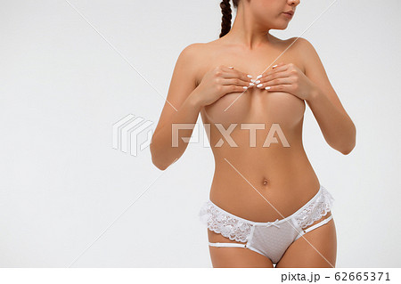 Crop sensual woman covering breast 62665371