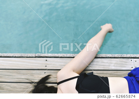 Happy girl relaxing around the swimming pool, Summer holiday vacation concept. 62665874