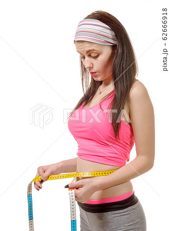 Young girl making measure around her waist with Young girl making measure around her waist with 62666918