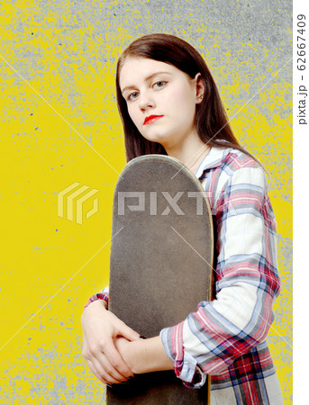 portrait of young skater girl holding a skateboard 62667409