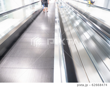 skywalk with blurred business people in airport 62668474