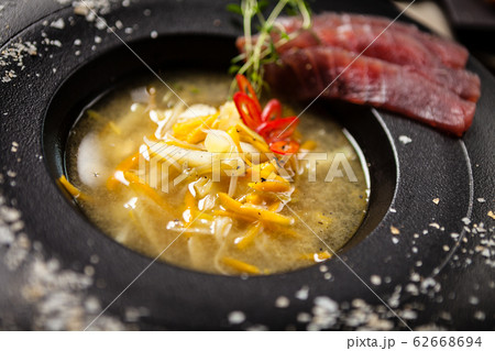 Clear Fish soup served in a bowl in restaurant 62668694