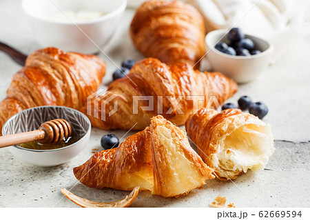 Fresh croissants with blueberries, butter  62669594