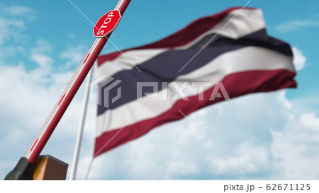 Opening boom barrier with stop sign against the Thai flag. Free border crossing or lifting a ban in Thailand. 3D rendering 62671125
