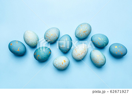 Easter background of eggs painted in blue color. 62671927