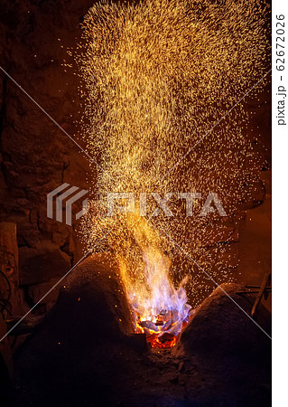 Smithy fire flame tips with sparks closeup Smithy fire flame tips with sparks closeup 62672026