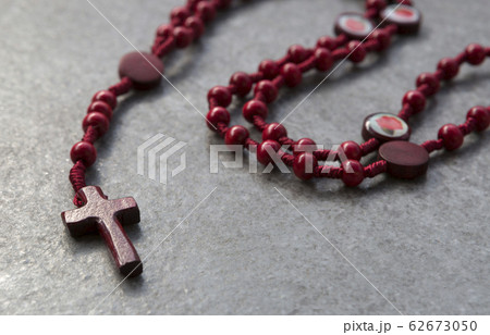 Red rosary on a stone background Red rosary on a stone background 62673050