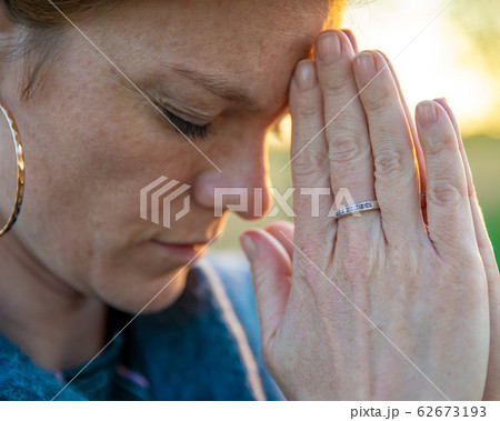 young woman meditates and pray at sunrice 62673193