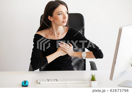 Heart pain. Woman having panic attack at workplace 62673796