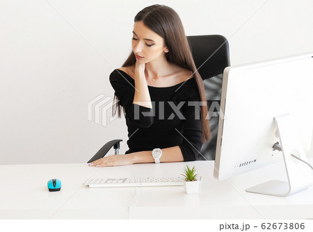 Pain neck. Tired business woman holding her neck 62673806