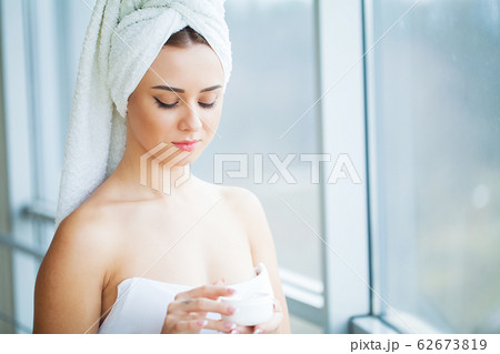 Beauty face of woman with cosmetic cream on face Beauty face of woman with cosmetic cream on face 62673819