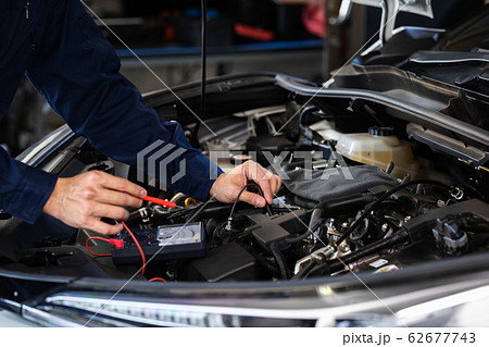 mechanics hand check electrical wiring vehicle 62677743
