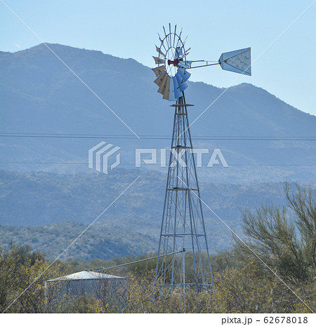 Windmill pumping water to the water tank in Mohave County, Sonoran Desert, Arizona USA 62678018