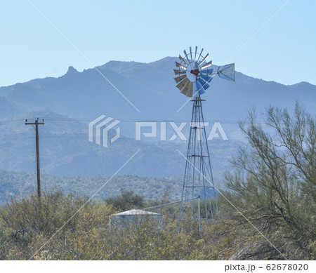 Windmill pumping water to the water tank in Mohave County, Sonoran Desert, Arizona USA 62678020