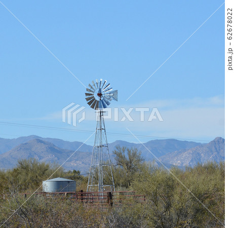 Windmill pumping water to the water tank in Mohave County, Sonoran Desert, Arizona USA 62678022