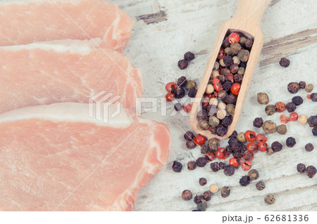 Slices of fresh loin with pepper on spoon 62681336