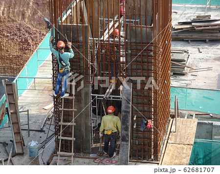 Construction workers working at height at the construction site. They are requested to wear appropriate safety gear to prevent bad happen to them. Construction workers working at height at the construction site. They are requested to wear appropriate safety gear to prevent bad happen to them. 62681707